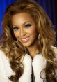 Beyoncé smiling brightly with glamorous hair and makeup, wearing a stylish white coat on a vibrant blue background.