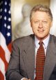 Bill Clinton smiling, wearing a gray suit and patterned tie, with an American flag in the background, showcasing presidential poise.