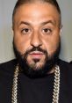 Dj Khaled sporting a stylish look with a gold chain and distinctive beard, capturing his iconic presence.