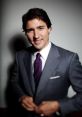 Justin Trudeau wearing a tailored suit and tie, smiling confidently against a neutral background.