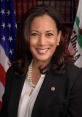 Kamala Harris smiling in a formal attire with pearls, U.S. flag in the background, representing leadership and progress.