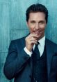 Matthew McConaughey in a stylish suit, smiling with a toothpick, exuding charm and charisma against a textured backdrop.