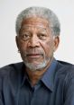 Morgan Freeman with a thoughtful expression, wearing a dark shirt, showcasing his signature gray hair and beard.