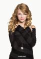 Taylor Swift poses with a charming smile, wearing a stylish black striped sweater, embodying her signature look and charm.