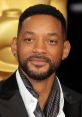 Will Smith looks dapper at a red carpet event, showcasing his stylish attire and confident expression.