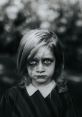 Creepy little girl with haunting makeup and intense gaze, evoking chilling emotions and dark folklore themes.