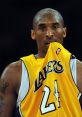 Kobe Bryant in a Lakers jersey, showing intense focus during a basketball game, showcasing his competitive spirit.