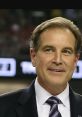 Jim Nantz smiling in a suit, known for his iconic sports commentary and hosting at major sporting events.