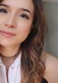 Close-up portrait of Pokimane, featuring her radiant smile and stylish hair, capturing her engaging personality and beauty.