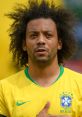 Marcelo, the Brazilian footballer, focused on the camera wearing the national team jersey with passion and pride.