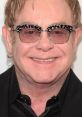 Elton John's iconic style shines through his unique sunglasses and confident smile, showcasing his vibrant personality.