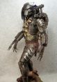 Detailed depiction of a Narin Predator figure showcasing intricate armor, weapons, and distinctive alien features.