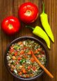 Fresh Chilean salsa with tomatoes, onions, and spicy peppers, served in a rustic bowl. Perfect for enhancing meals.