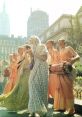 Groups of people in traditional attire joyfully chanting and playing drums outdoors in an urban setting.