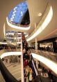 Shopping-Center The cacophony of noise fills the air as I step into the crowded and bustling shopping center. Laughter,