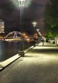 Night view of the Yarra River promenade in Melbourne, lined with street lamps and illuminated pathways.