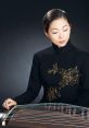 Guzheng The delicate notes of the Guzheng resonate through the air, creating a tranquil atmosphere that transports listeners