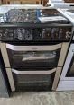 Belling double oven cooker with sleek black design and stainless steel accents, featuring multiple control knobs for precise cooking.