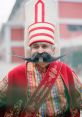 Traditional Turkish man in colorful attire with distinctive hat and elaborate mustache, showcasing Turkish culture and heritage.