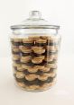 Cookie-Jar In the warm and cozy kitchen, the familiar of the cookie jar being opened and closed can be heard. The gentle