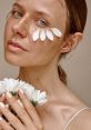 Natural beauty portrait featuring a woman with flower petals on her face, showcasing a fresh skincare aesthetic.