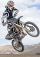 Motocross The revving engine of a motorcycle echoes through the air as a dirt bike approaches the starting line at the