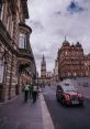 Busy Glasgow street scene with historic architecture, police presence, and iconic red taxi on a cloudy day.