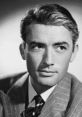 Classic black and white portrait of a stylish man with slicked-back hair in a pinstripe suit, exuding vintage Hollywood charm.