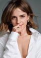 Emma Watson poses thoughtfully in a stylish white shirt, showcasing natural beauty and elegance, perfect for promoting fashion.