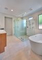 Modern bathroom featuring a sleek Jacuzzi, glass shower enclosure, and minimalist design, perfect for relaxation.