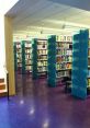 Modern library interior featuring colorful bookshelves and vibrant purple flooring, ideal for quiet study and exploration.