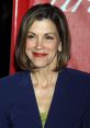 Wendie Malick smiling confidently in a stylish blazer, showcasing her timeless beauty and elegance at a red carpet event.