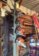 Four chainsaws neatly organized on a wooden post in a well-stocked workshop library for woodwork enthusiasts.