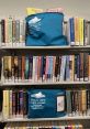 Prescott Public Library book bags on shelves, showcasing the "Books by Mail" service for convenient reading access.