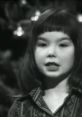 Young Björk talking, showcasing her early charisma and talent in a nostalgic black-and-white setting.