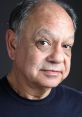 Cheech Marin posing for a portrait, showcasing his signature smile and expressive eyes, reflecting his comedic style.