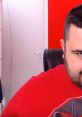 Cicciogamer89 smiles playfully in a red shirt, showcasing his engaging personality and love for gaming content.