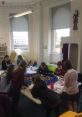 Children engaged in creative activities at a busy library, showcasing collaboration and learning in a vibrant space.