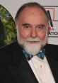 Jerry Nelson, known for voicing Count Von Count, smiles warmly in a tuxedo with a plaid bow tie at an event.