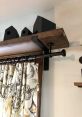 Curtain rod Library The rich, deep of a thick curtain being pulled along a metal pole with metal eyelets fills the library,