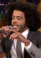 Daveed Diggs rapping passionately, microphone in hand, showcasing his dynamic vocal talent on stage.