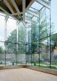 Bright and spacious interior of the Aluminium Library, featuring glass walls and modern architecture with wooden beams.