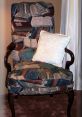 Cozy chair adorned with a colorful book-patterned fabric and a soft cloth pillow, perfect for a library reading nook.