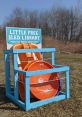 Little Free Sled Library with colorful sleds for community fun, encouraging sharing and outdoor activities during winter.