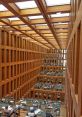 Spacious interior of Berlin Library featuring wooden architecture and numerous study areas filled with students.