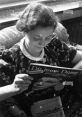 Young lady reading a magazine in a cozy library setting, showcasing her interest in fashion and culture.