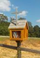 Loosen Library mailbox with cross, displaying books inside; a charming community sharing space in a scenic outdoor setting.