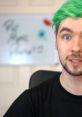 JackSepticEye, known for his vibrant green hair, engages viewers with a friendly expression and motivational backdrop.