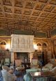 Elegant Breaker Library interior with ornate ceiling, vintage furnishings, and a grand stone fireplace. Classic literary ambiance.