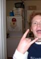 Energetic young man making a rock sign in a laundry room, embodying the rebellious spirit of Jimmy Hopkins.